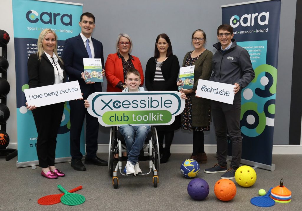 Xcessible Club Toolkit Launch with stakeholders holding inclusive signage